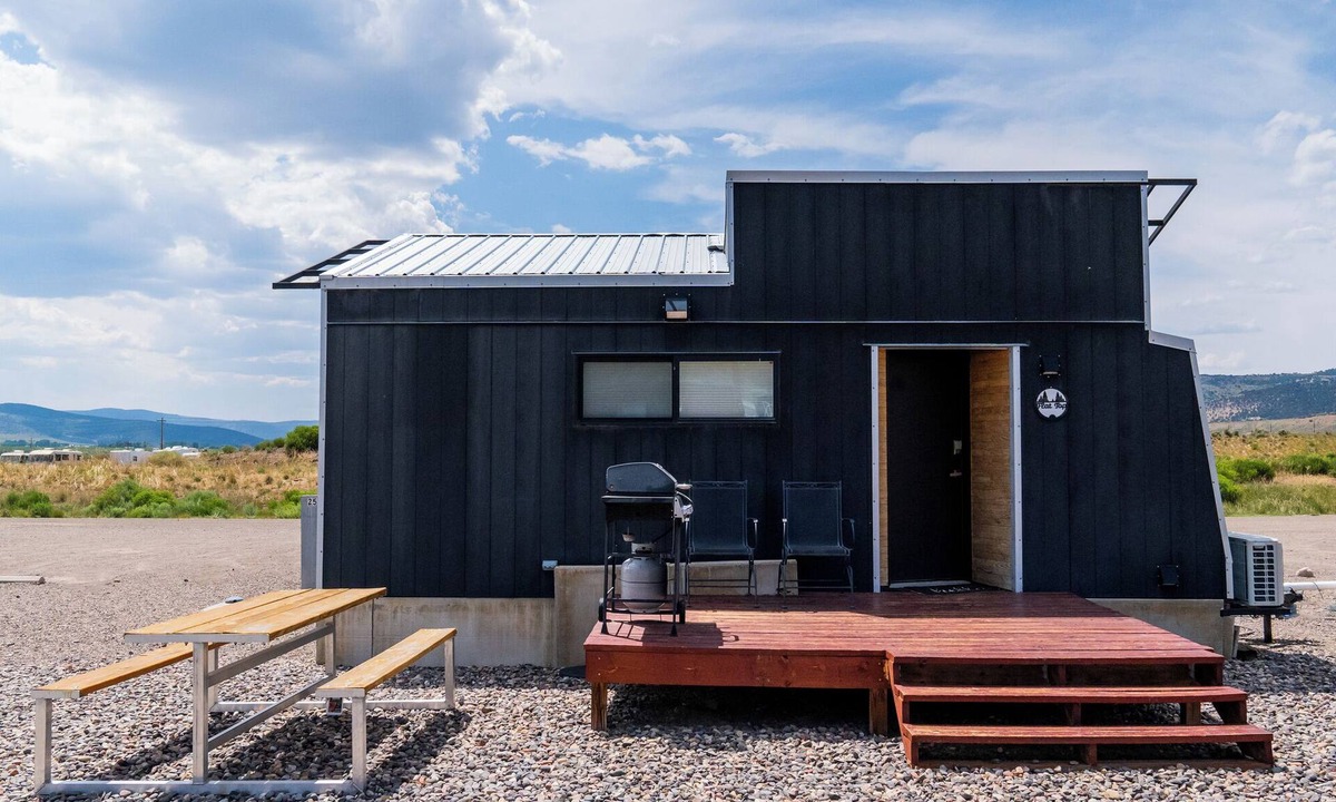 Meeker House | This Tiny Home is custom made by a Colorado craftsman has one Queen bed in loft accessible by stairs and also has a fold out Full futon on main level. Sleeps up to 4. Please note, this home does have a sleeping area in a loft. If you require an accom