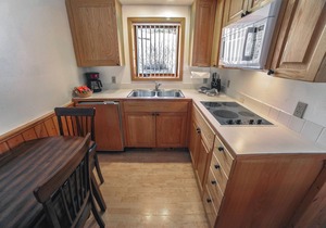 1 bedroom, 1 bath attached cabin, kitchen, wood burning fireplace