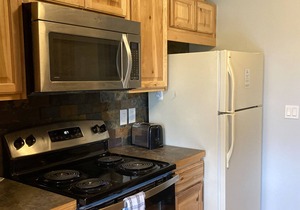 Ground-Floor, All-Seasons Condo with Shaded Deck, Fireplace & Shared Hot Tubs
