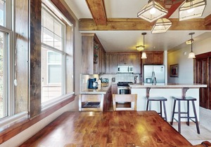 Mountain-view condo on ski shuttle route with deck & fireplace