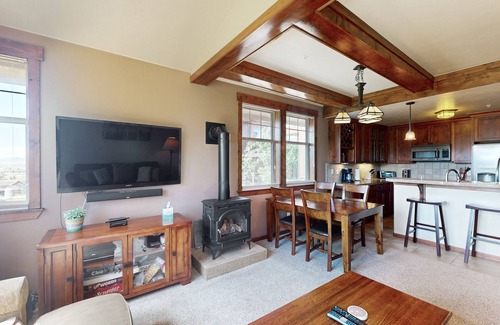 Fraser House | Mountain-view condo on ski shuttle route with deck & fireplace