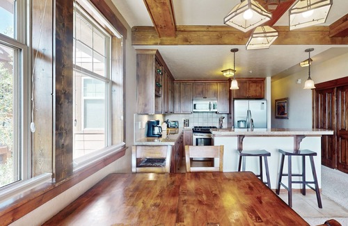Fraser House | Mountain-view condo on ski shuttle route with deck & fireplace