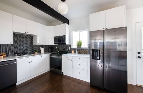Lamar Heights Area House | Group friendly Denver home with hot tub, fire pit, large dining, & big backyard.