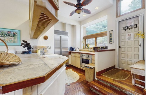Woody Creek House | Lush tropical villa with garden paths, river views, and high-end comfort