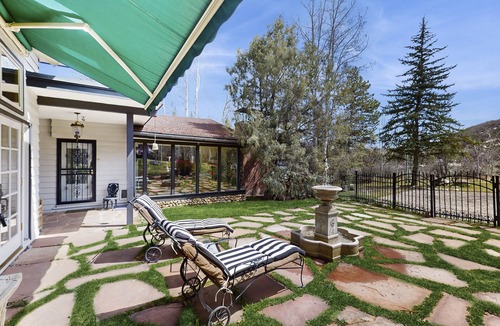 Woody Creek House | Lush tropical villa with garden paths, river views, and high-end comfort