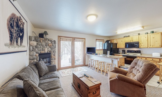 Grand Lake Condo | Riverfront condo with free wifi, fireplace, patio, & gas grill